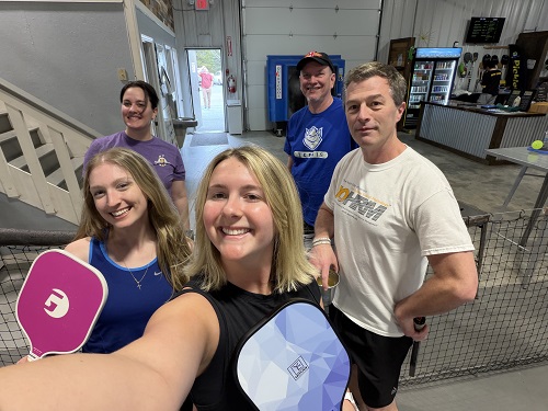 IOHRM students and faculty in a pickleball court