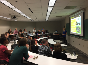 Lorin Farr giving a presentation to a full classroom of audience members