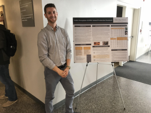 Cody Rusher with research poster